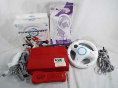 A Nintendo Wii with steering wheel and accessories