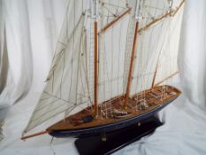 A model three masted yacht in full sail,