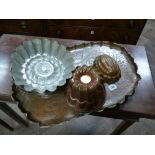 Arts and crafts copper tea tray and a collection of jelly moulds