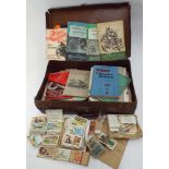 Small suitcase full of cigarette cards, cigarette cards in albums, motorcycle manuals etc.