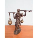 Bronze figure ornament of an Arab playing a pipe carrying a water yoke signed Dermedaonda approx
