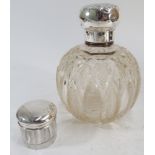 Large Edwardian cut glass silver mounted eau de toilette bottle and a smaller silver topped