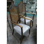 Pair of 1930s walnut framed elbow chairs with cane panelled backs and pale green upholstered seats