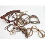 Collection of old horse bits and stirrups