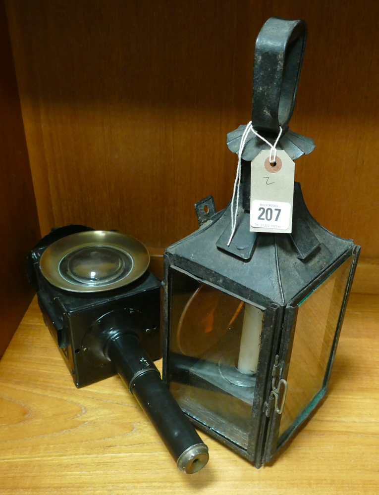 Old black and glass metal lantern and a black painted carriage lamp