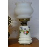 Floral decorated porcelain oil lamp with glass bowl shade