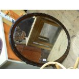 Oval bevelled wall mirror in mahogany frame