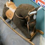 Childs brown material covered rocking horse