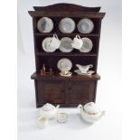 1930's oak dolls dresser complete with tea service etc.