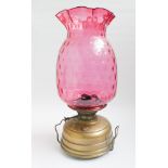 Late Victorian brass oil lamp with cranberry glass shade 21" tall