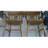 Pair of rounded backed Windsor elbow chairs