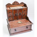 Oak stationery cabinet fitted centre cupboard and numerous drawers with brass pen holder top