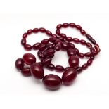 Long vintage row of red amber beads, of graduated size, largest bead measures 2.1 cms across.