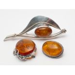 Three amber brooches