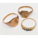 Three 9ct gold rings, two signet rings and an emerald half hoop, gross weight 9.8 grams.