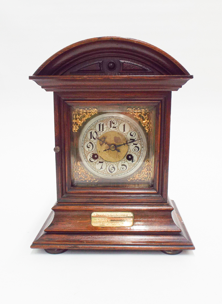 Edwardian striking bracket clock in oak case with brass and silver dial