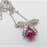 18ct white gold ruby and diamond pendant set with a tear drop shaped ruby with X shaped diamond