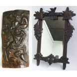 Black Forest style wall mirror and an African carved wooden plaque