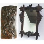 Wall mirror in Black Forest style carved frame and carved wooden African plaque