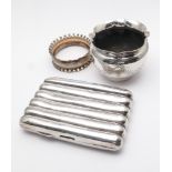 Silver cigarette case, napkin ring and a salt cellar, gross weight 3.