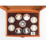 Mahogany presentation box containing 9 medallions of the Queens of the British Isles,