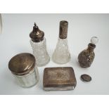 Oriental silver overlaid scent bottle and selection of other dressing table jars with silver tops