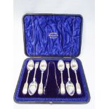 Cased set of six silver teaspoons and matching sugar nips in blue velvet case,