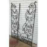 Pair of black wrought iron hinged panels approx 5' tall.