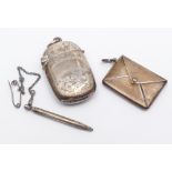 Silver envelope stamp case with attached miniature propelling pencil and a vesta case.