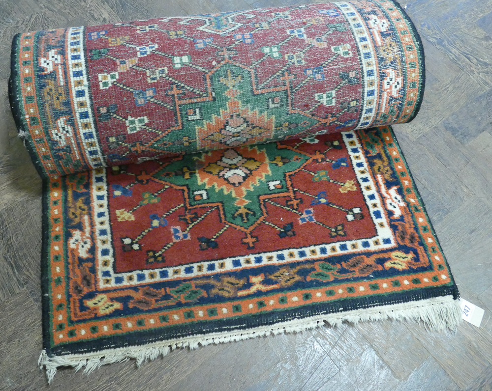 Red and patterned woolpile Persian design rug