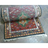 Red and patterned woolpile Persian design rug