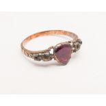 Antique ruby and diamond ring set with heart shaped foil backed ruby flanked by small old cut