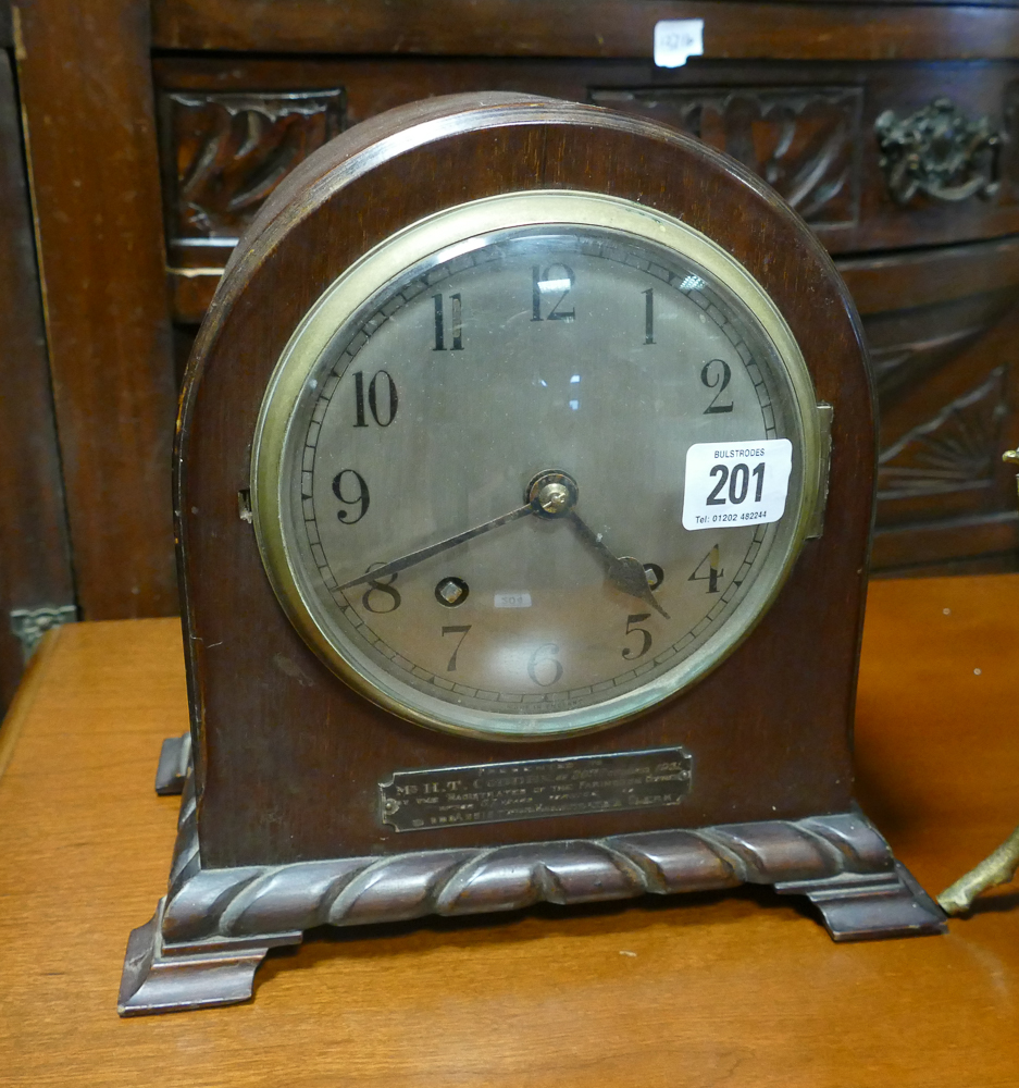 Striking mantel clock in dome topped mahogany case