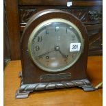 Striking mantel clock in dome topped mahogany case