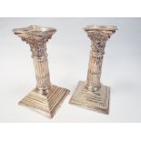 Pair of Edwardian silver corinthian column candlesticks with removable sconces on square bases with