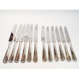 Set of six silver handled table knives, and six matching silver handled dessert knives,