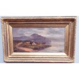 Oil on canvas painting of highland cattle in a loch side view. Indistinctly signed. Gilt frame.