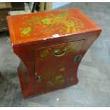 Small red lacquered and gilt decorated low cupboard with fitted drawer