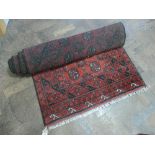 Red and patterned woolpile rug