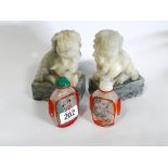 A pair of soap stone temple lion ornaments and a pair of Chinese snuff bottles