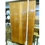 A lacquered finished walnut 2 door wardrobe