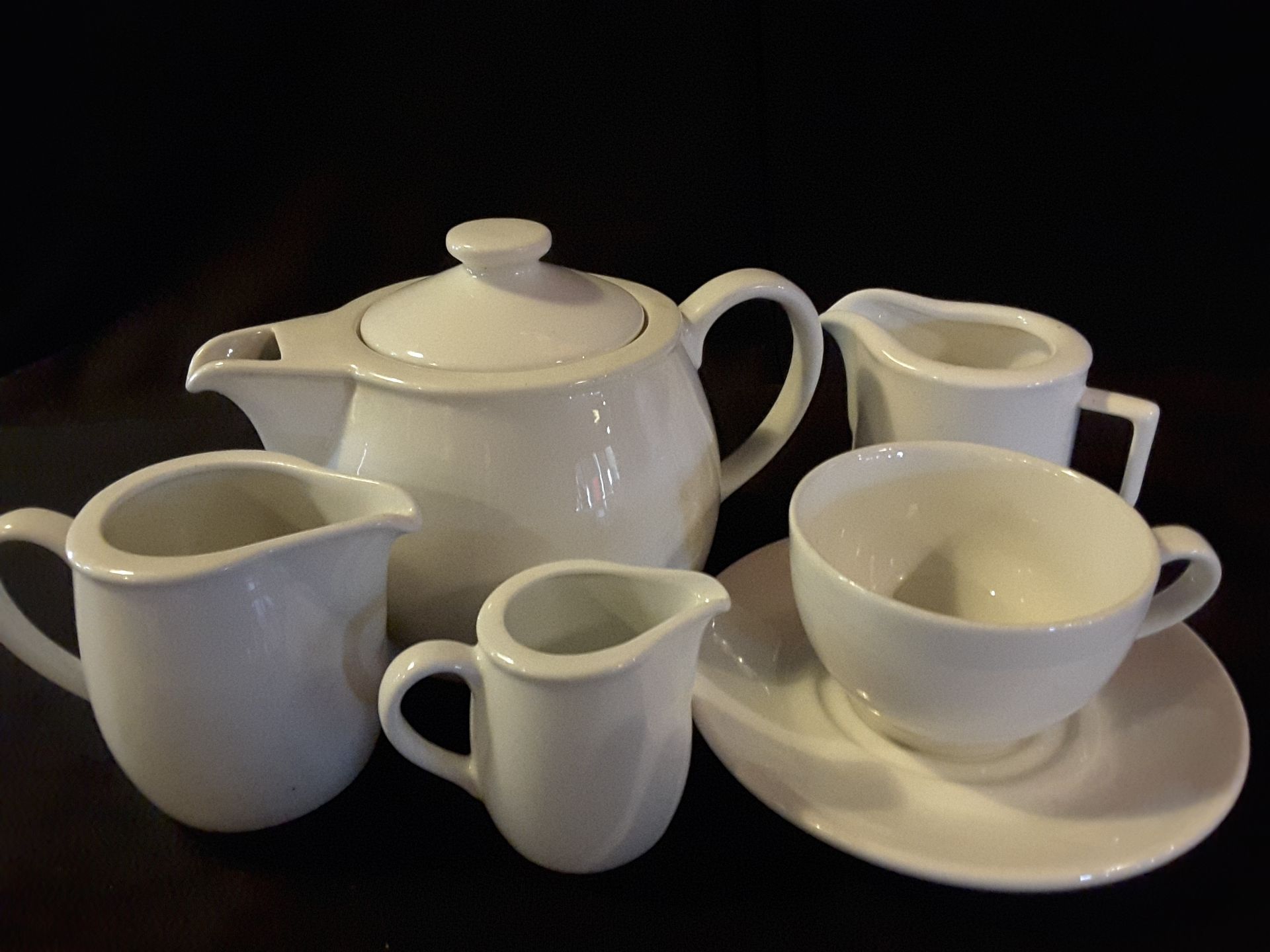 Assorted crockery including 2 Tea pots, milk jugs, 28 saucers, 8 cups