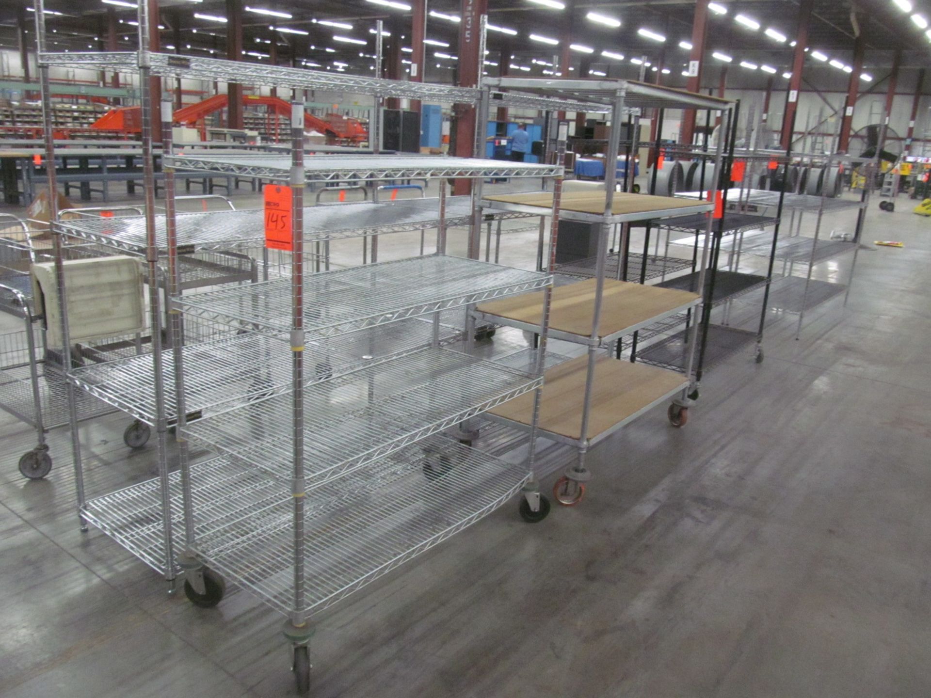 Lot of (4) assorted shelving units all 4' long-(3) units on casters
