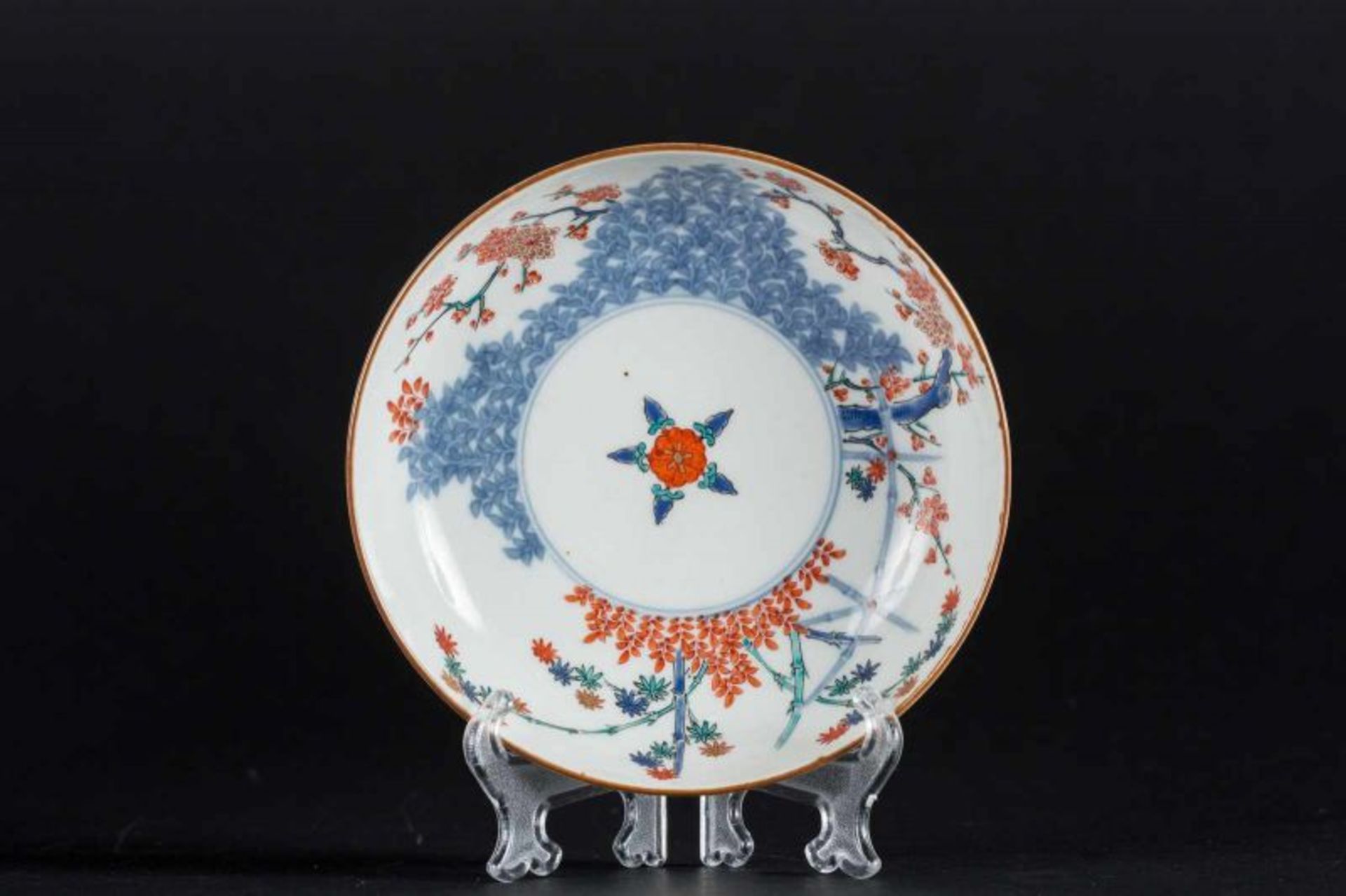 A Kakiemon porcelain dish painted with floral motif and bearing a circle mark at the base Japan,