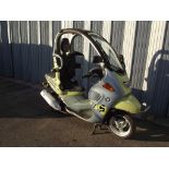 A 2002 BMW C1, registration number PN52 UXZ, yellow and grey.