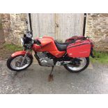 A 1986 Honda XBR500F, registration number HAZ 6142, red.