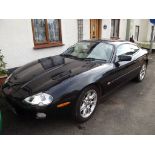 A 2001 Jaguar XK8, registration number Y824 FEP, black.