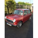 A 1984 Mini Mayfair, registration number B199 VYD, red.