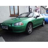 A 1993 Honda CRX, registration number L342 BPK, green.