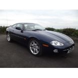 A 2002 Jaguar XK8, registration number HG02 LFA, sapphire blue.